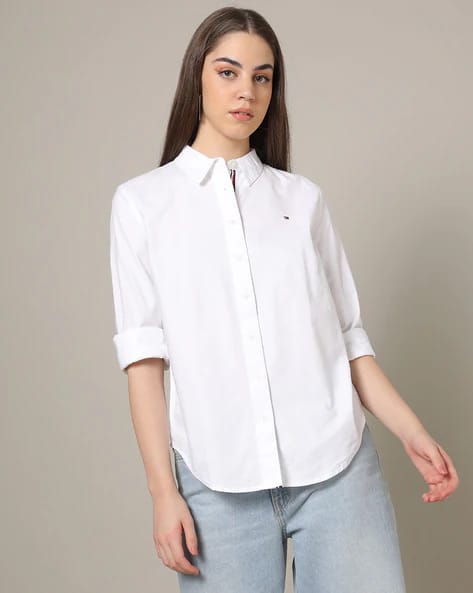 A classic Tommy Hilfiger Oxford shirt in crisp white with a button-down design and an embroidered logo on the chest for timeless elegance.